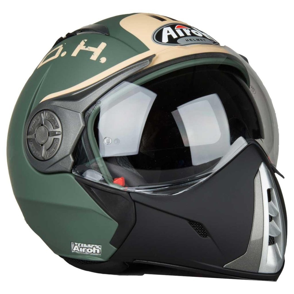 The کلاه کاسکت آیرو مدل J106G is a matte green and beige motorcycle helmet with a clear visor, black chin guard, Airoh branding on the front, and an angular, modern aerodynamic design.
